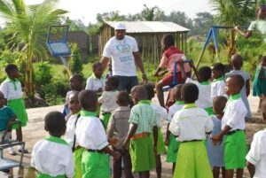 Volunteers distribute bottled water and supplies to diverse individuals in an outdoor setting, showcasing community support.