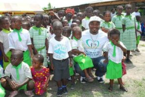 Portrait of a woman in hijab volunteering at a donation center with diverse helpers.